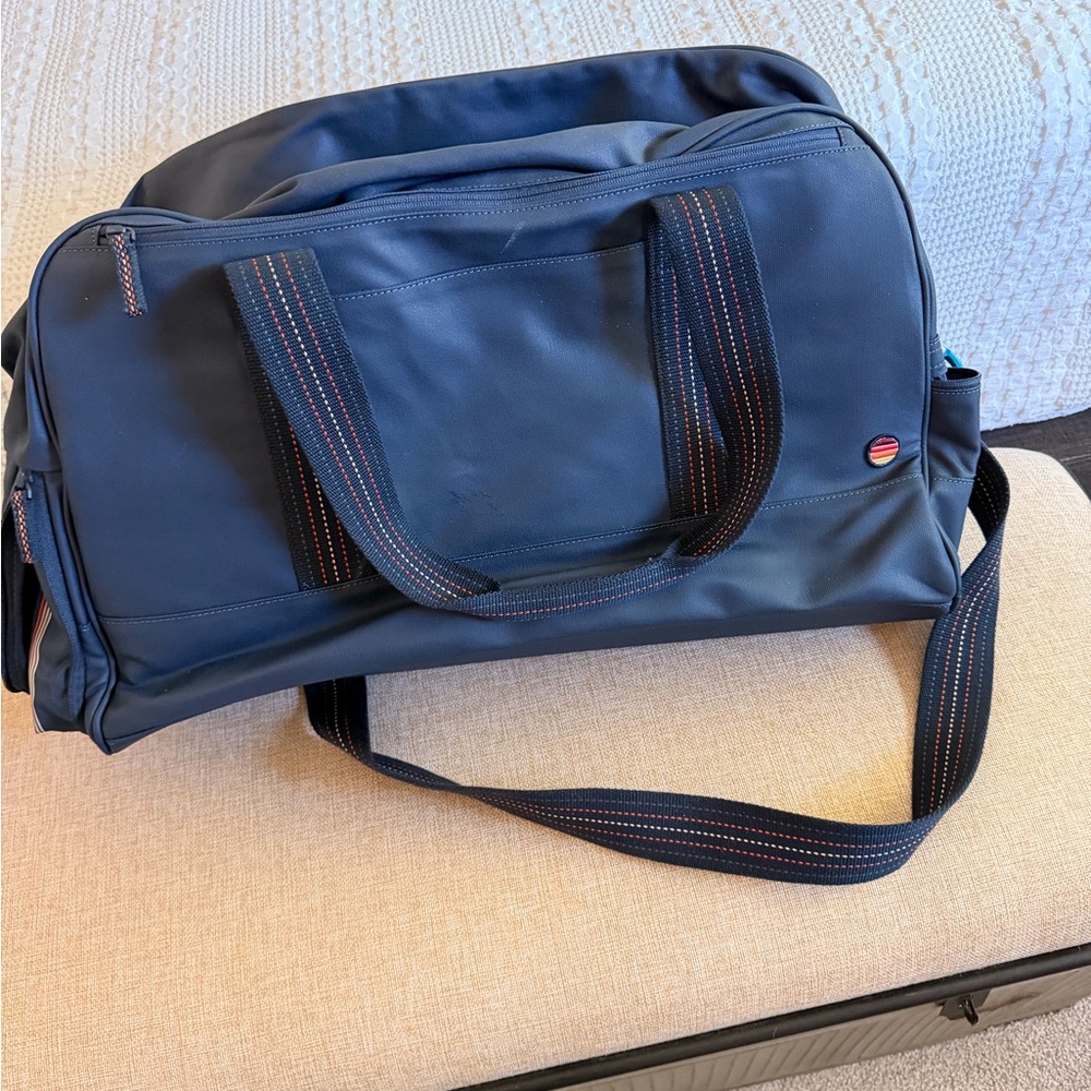 Marine Layer large duffle bag with shoe compartment.  Opening to fit on suitcase